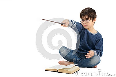 Little cute boy is reading a book and imagining himself a hero Stock Photo