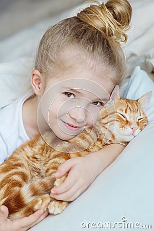 Little cute girl affectionately hugging kitten Stock Photo