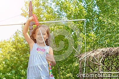 Little cute girl blowing soap bubbles is smiling Stock Photo