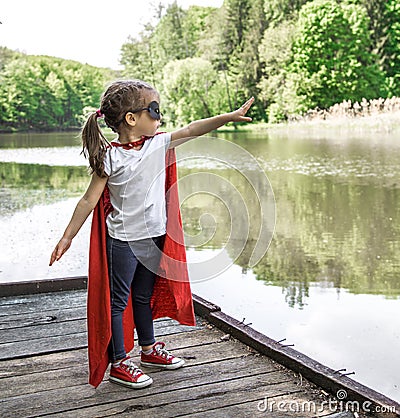 Little cute girl in costume of a super hero Stock Photo