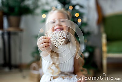 A little cute girl dreams of gifts. Girl making a wish. Merry Christmas and Happy Holidays Stock Photo