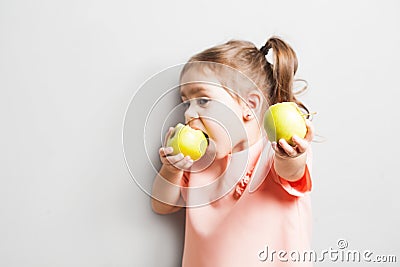 Little cute girl eating apple. inscription Go Vegan Stock Photo