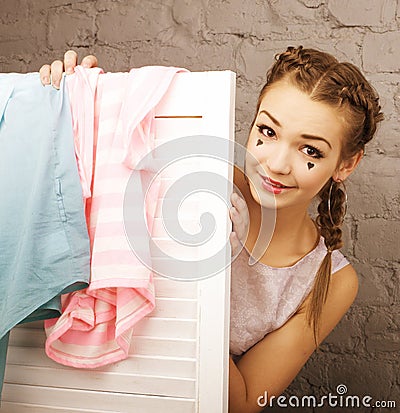 Little cute girl at her dressing room like doll make up, toys concept Stock Photo