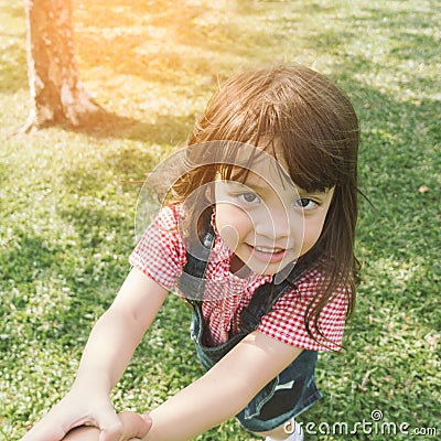 Little cute girl holding hands parents looking at camera Stock Photo