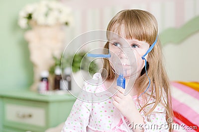 Little cute girl makes inhalation home Stock Photo