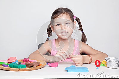 Little cute girl molds from clay mass Stock Photo