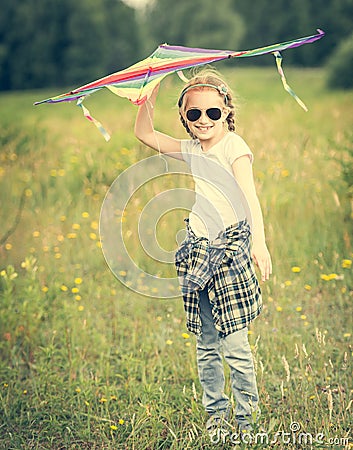 Little cute girl posing with a kite Stock Photo