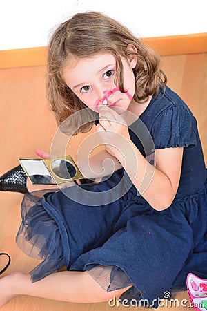 Little cute girl posing while panting her face Stock Photo