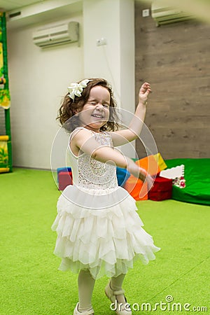 Little cute girl in a puffy dress plays on holiday Stock Photo