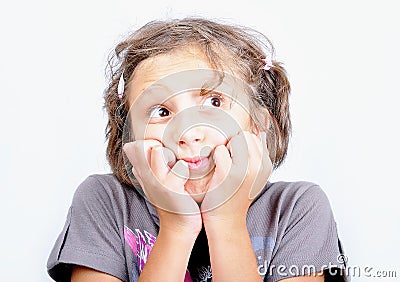 A little cute girl with strange expression on face Stock Photo