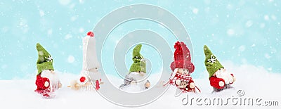 Little cute girls and christmas gnomes standing in the snow, festive greeting card, copy space Stock Photo