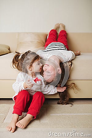 Little cute girls on the couch upside down Stock Photo