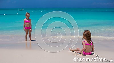 Little cute girls walking on white beach during Stock Photo