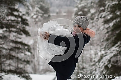 Little cute happy girl sculpts snowman. Stock Photo