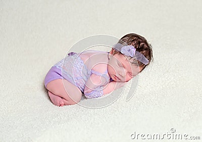 Infant baby girl in lace violet outfit Stock Photo