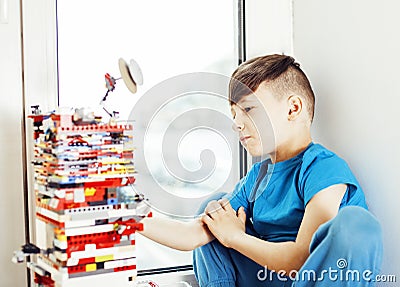 little cute preschooler boy playing lego toys at home happy smil Stock Photo