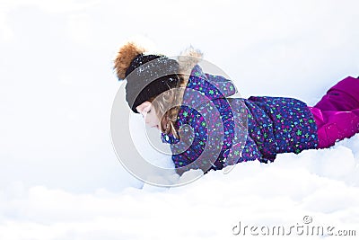 Little cute toddler girl outdoors on a sunny winter day. Stock Photo