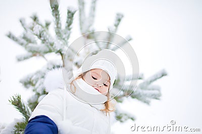 Little cute toddler girl outdoors on a sunny winter day. Stock Photo