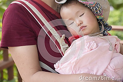 Little daughter lie on moms chest sleeping Stock Photo
