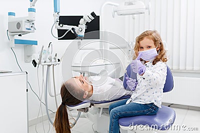 Little dentist girl gesturing thumb up Stock Photo