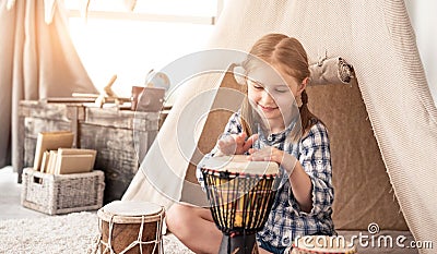 Little drummer girl playing on djembe Stock Photo