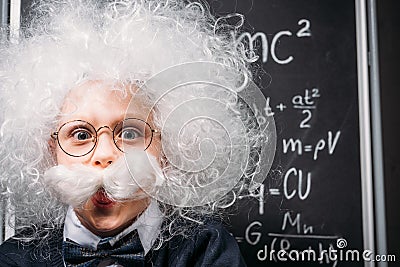 little Einstein in eyeglasses with theory of relativity Stock Photo