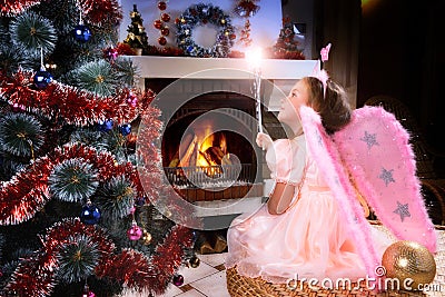 Little fairy girl near a Christmas tree Stock Photo