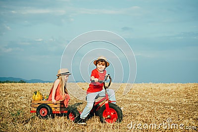 Little family farmers. Eco farm for kids. Children farmers in the farm with countryside background. Springtime on the Stock Photo