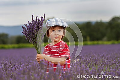 Little fashionable boy having fun in lavender field Stock Photo