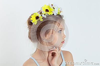 Little fashionista in profile. Closeup portrait serious little Girl thinking daydreaming having idea hand on chin in wreath of Stock Photo
