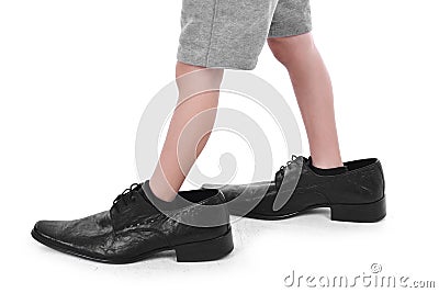 Little feet in big shoes Stock Photo