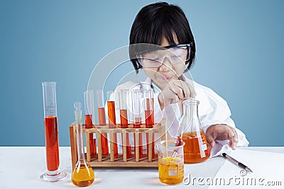 Little female scientist doing tests Stock Photo