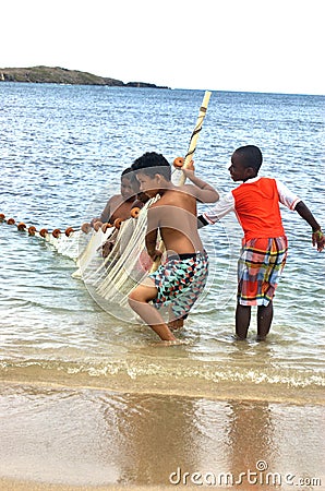 Little fishermen team with net trying caught fish Editorial Stock Photo