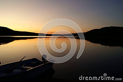 Little fishing boat on a wild lake in the Canadian forest Stock Photo