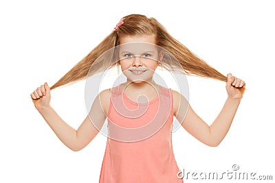 Little fun joyful girl in a pink shirt holds hands hair, isolated on white background Stock Photo