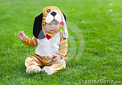 Little funny baby wearing puppy suit Stock Photo