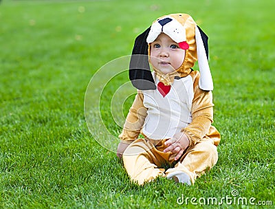 Little funny baby wearing puppy suit Stock Photo