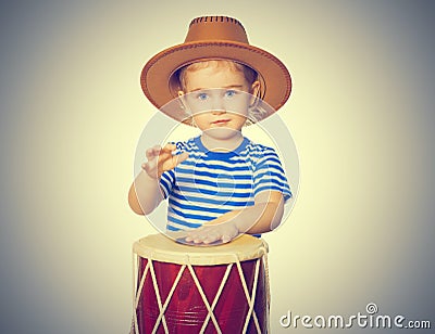 Little Funny girl play drum. Stock Photo