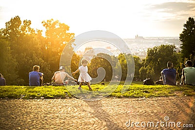 Little funny girl playing on green grass, Prague, august 2015 Editorial Stock Photo