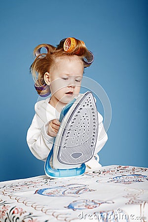 Little funny housewife with iron Stock Photo