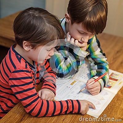 Little genius boy help his brother with homework Stock Photo