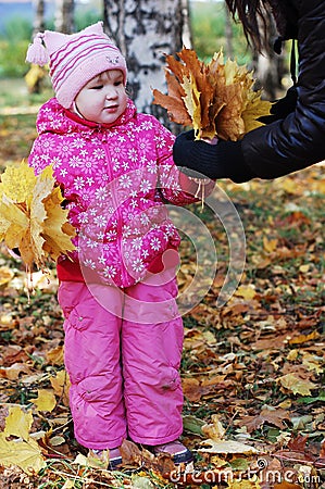 Little girl in autumn park Stock Photo