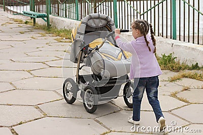 Little girl with baby carriages Stock Photo