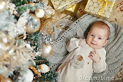 Little girl baby lying on the background of Christmas interiors Stock Photo
