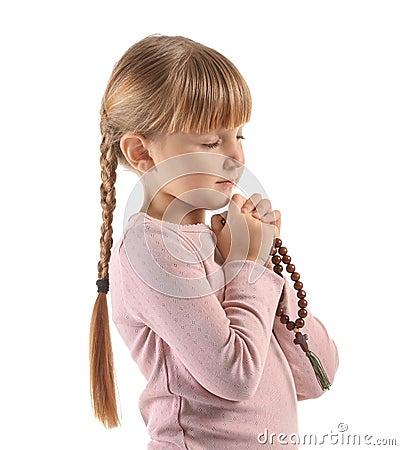 Little girl with beads praying on white background Stock Photo