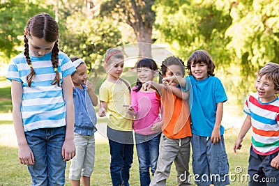 Little girl being bullied in park Stock Photo