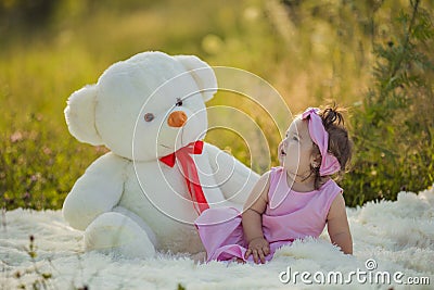 little girl with a big teddy bear Stock Photo