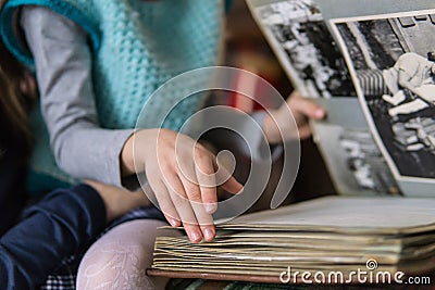 Little girl leafing through a family album Stock Photo