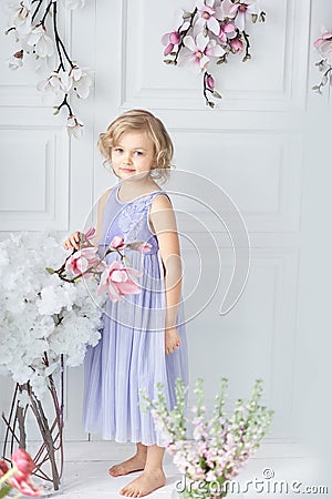 little girl with a bouquet of spring flowers. little cute holding bouquet as present for mother father day. Stock Photo