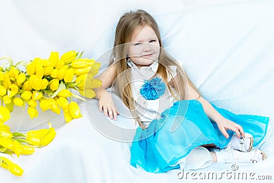 Little girl with bouquet of tulips Stock Photo